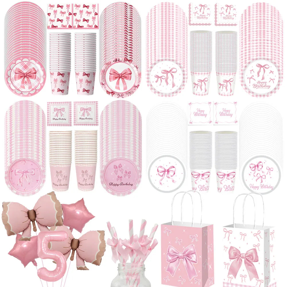 A collection of pink disposable party tableware including plates, cups, and napkins with bow designs.