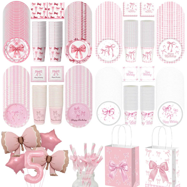 A collection of pink disposable party tableware including plates, cups, and napkins with bow designs.