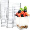 A clear glass set of six elegant mini dessert cups with spoons filled with fresh fruit