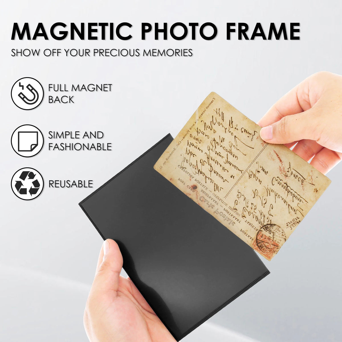 A hand holds a black magnetic photo frame with a piece of aged paper inside, demonstrating its reusable and fashionable featu