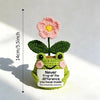 Hand crocheted frog ornament with pink flower and green leaves