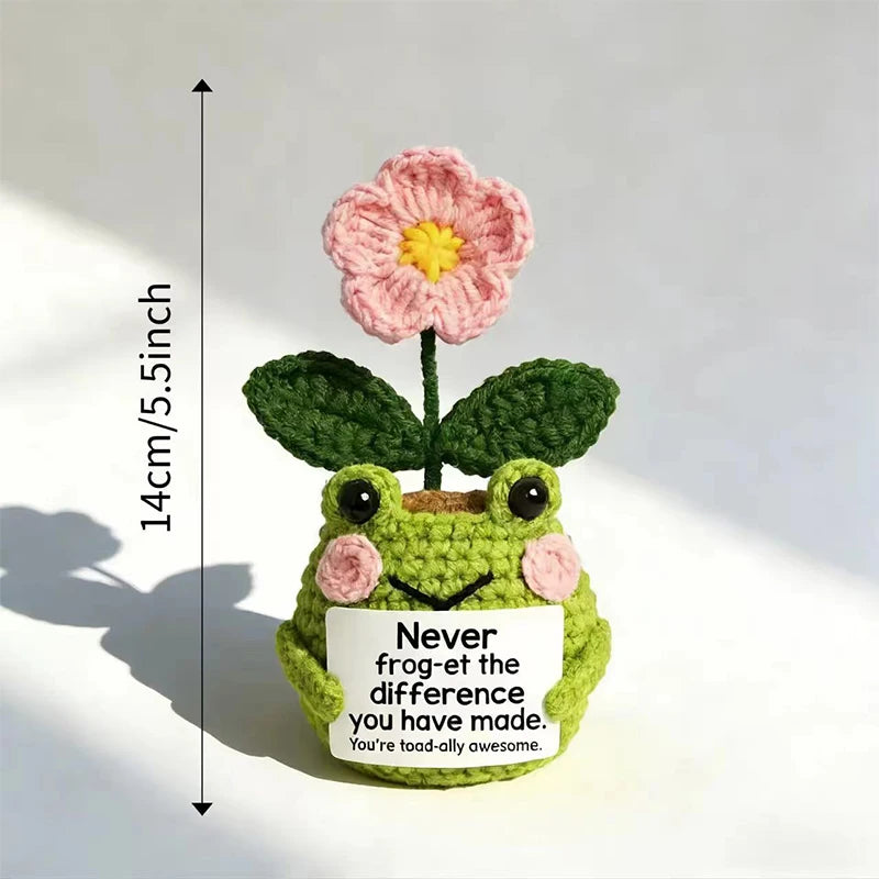 Hand crocheted frog ornament with pink flower and green leaves