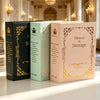 Three vintage gold foil photo albums in black, mint green, and blush pink displayed on a white surface.