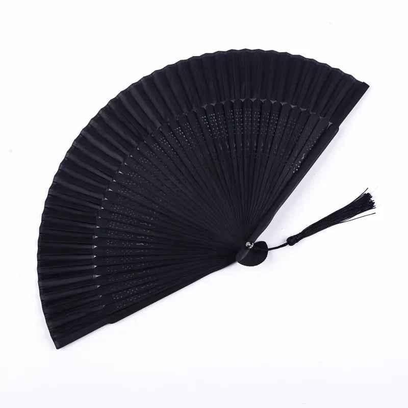 Black traditional Chinese folding fan with pleated paper blades.
