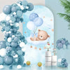 A vertical arrangement of blue and white balloons with a baby sleeping on a cloud backdrop decorated for a party.