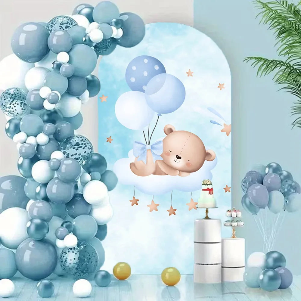 A vertical arrangement of blue and white balloons with a baby sleeping on a cloud backdrop decorated for a party.