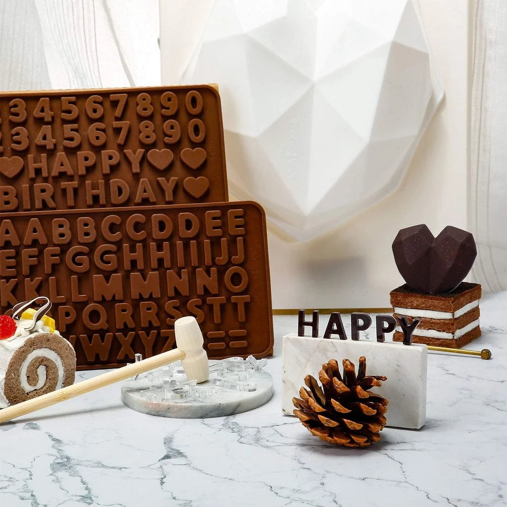 A set of heart-shaped silicone chocolate molds featuring letters and numbers arranged in a decorative pattern.