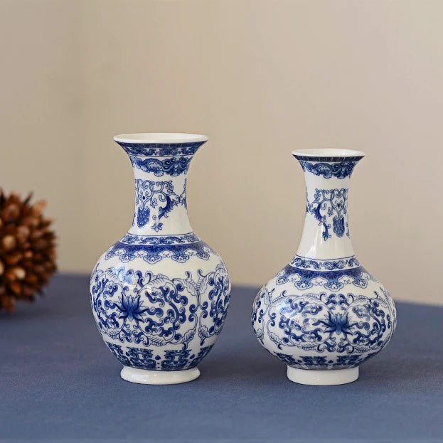Blue and white ceramic flower vase with intricate floral patterns on a gray surface.