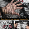 A hand is tearing or cutting black creepy gauze cloth for Halloween decor.