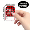 A hand holds a roll of 100 Christmas present stickers featuring a red and black plaid pattern with the text Merry Bright