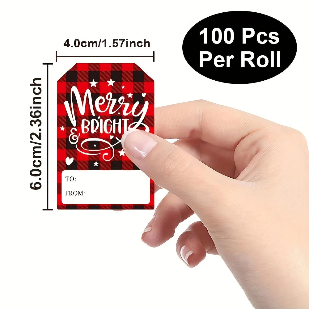 A hand holds a roll of 100 Christmas present stickers featuring a red and black plaid pattern with the text Merry Bright