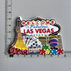 A set of fridge magnets featuring iconic Las Vegas imagery including the Eiffel Tower, casino chips, and colorful Vegas symbo