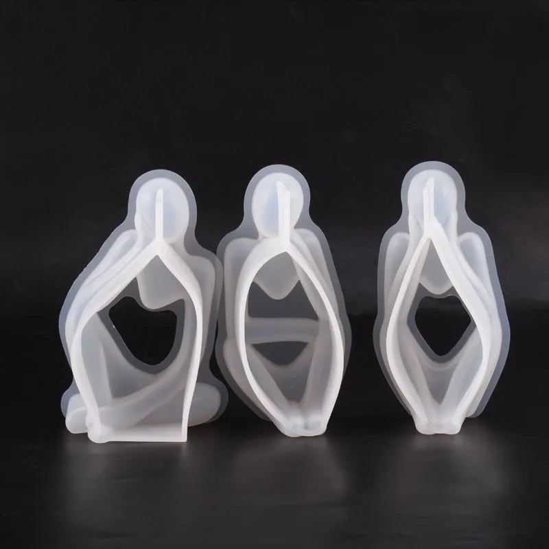 Three clear silicone molds shaped like abstract leaves or petals for resin art and crafting