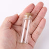 A hand holds a glass cork stopper with a white stick inside, used for DIY decor.