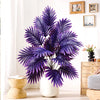 A realistic artificial palm tree with vibrant purple silk leaves displayed indoors.