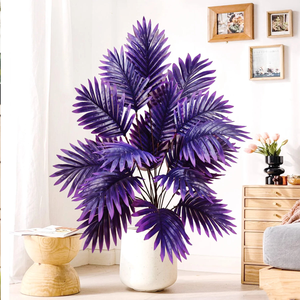 A realistic artificial palm tree with vibrant purple silk leaves displayed indoors.