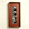A rectangular walnut wood photo strip frame displaying a series of portrait photographs.