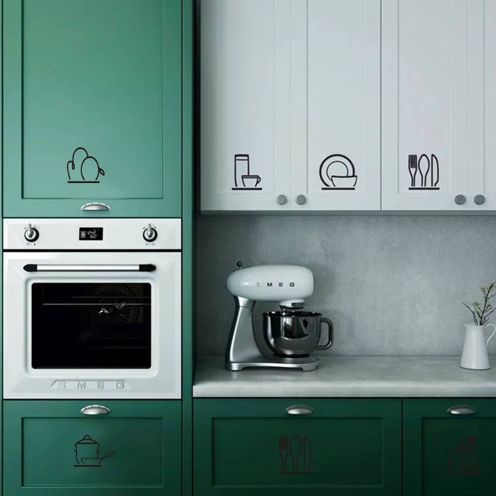 A green kitchen cabinet featuring decorative wall stickers for appliances and cutlery.