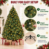 A fully decorated artificial Christmas tree with green foliage and warm white lights, shown next to gift boxes and setup inst