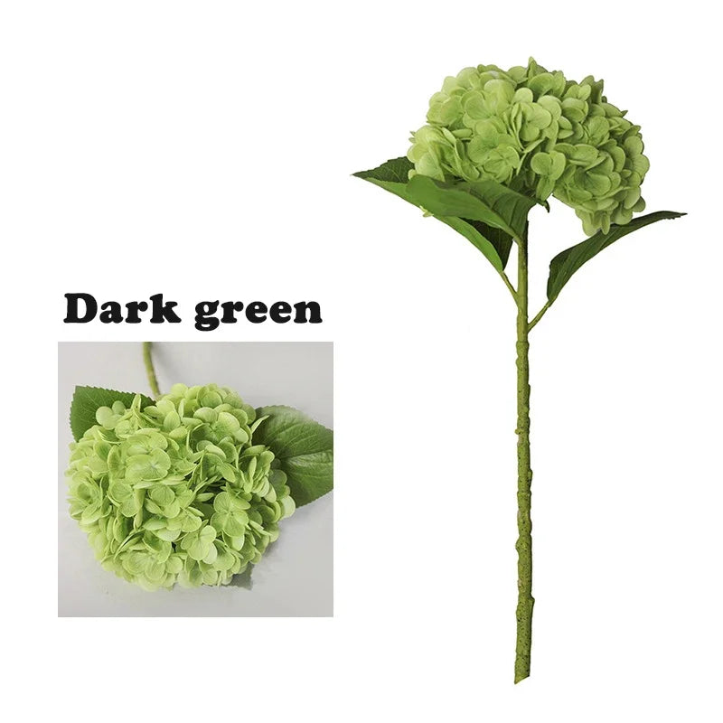 A stem of dark green artificial hydrangea flowers with large green leaves.