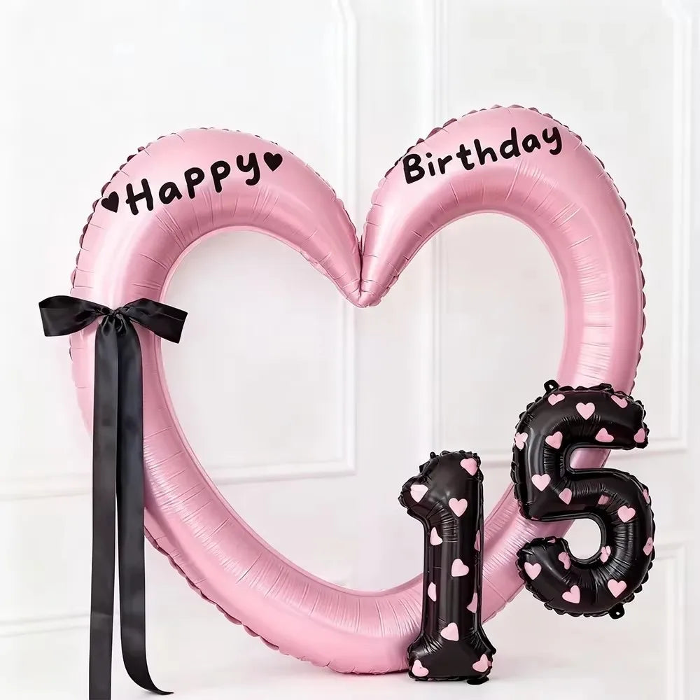 Pink heart-shaped balloon decoration with Happy Birthday text and the number 15