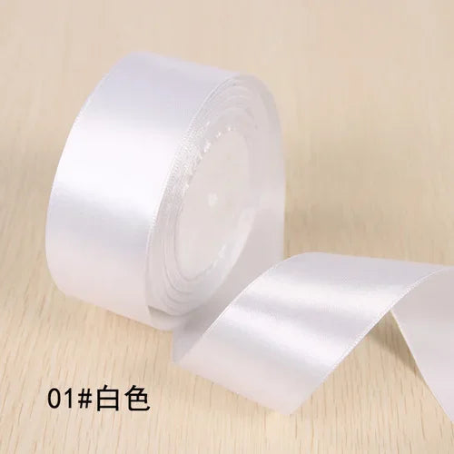 Roll of white silk satin ribbon for gift wrapping and craft projects