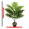 A potted artificial palm tree with 12 green monstera leaves used for indoor floor decor.