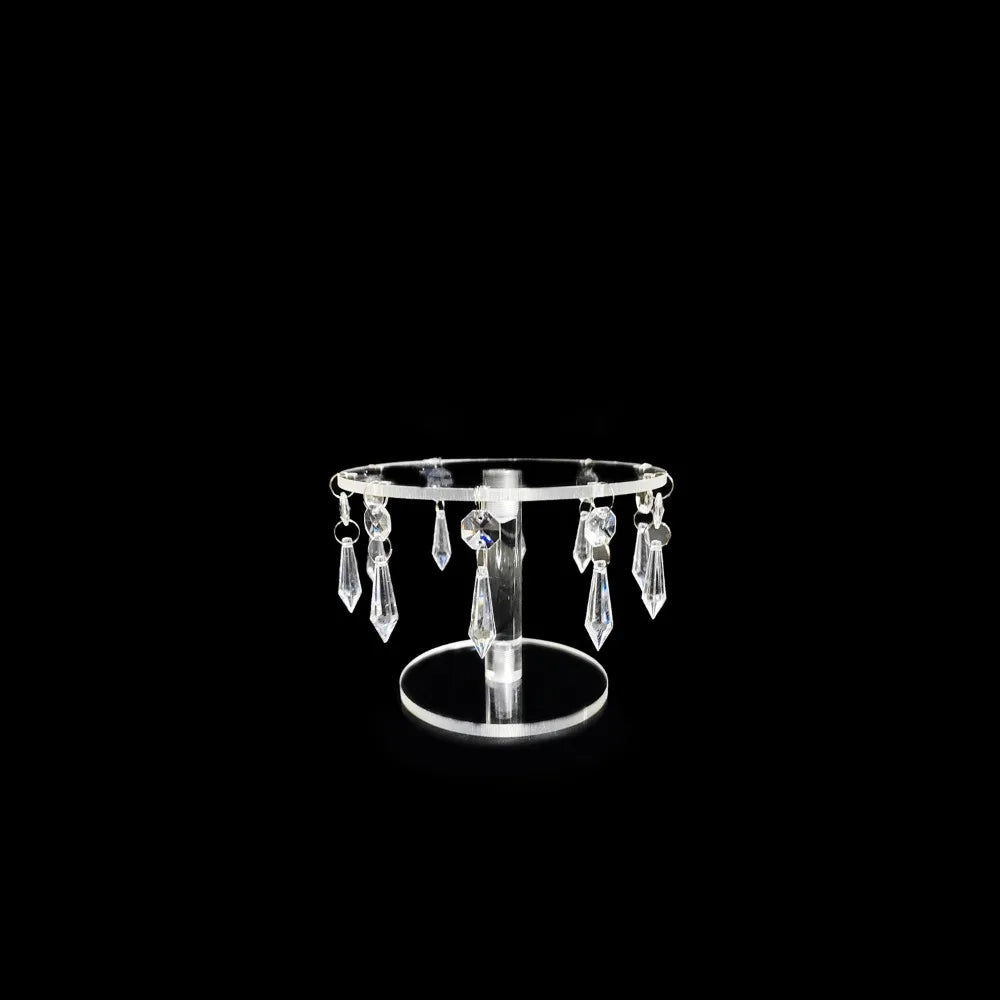 Elegant transparent acrylic cake display rack with hanging decorative elements.