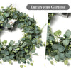 A green eucalyptus garland featuring silvery-green leaves and small white flowers for decoration.