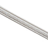 Close-up of a white decorative corner wall trim strip with an embossed scroll pattern.
