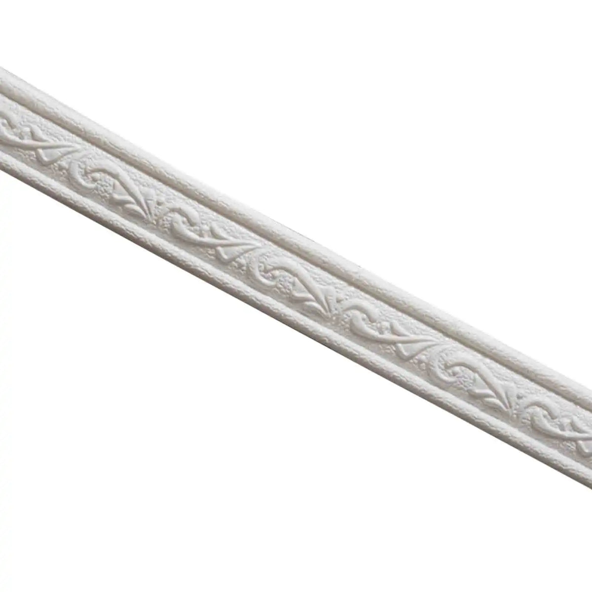 Close-up of a white decorative corner wall trim strip with an embossed scroll pattern.