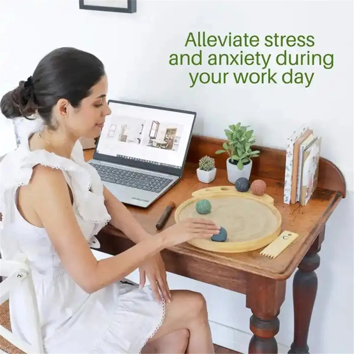 A woman is relaxing while using a Japanese sensory sand table for stress relief during her workday.