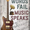 Placa de metal desgastada con el texto 'Where Words Fail Music Speaks' superpuesta en una guitarra eléctrica.
