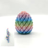 A 3D printed dragon egg fidget toy shaped like a cone, featuring a gradient of pastel colors.