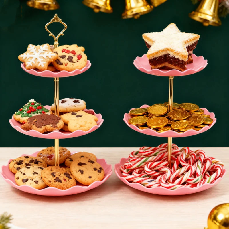 A three-tier pink dessert rack displaying various cookies and a star-shaped pastry on a wooden surface.