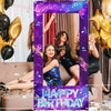 A festive photo frame backdrop for a birthday party featuring gold balloons, purple glitter, and women in black dresses.