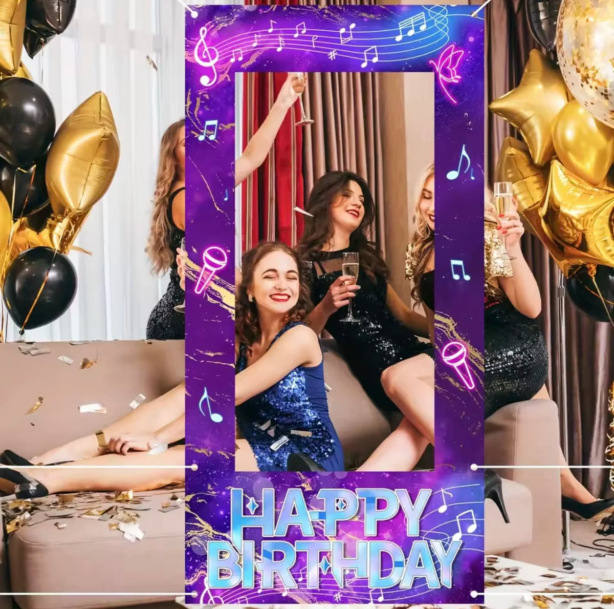 A festive photo frame backdrop for a birthday party featuring gold balloons, purple glitter, and women in black dresses.