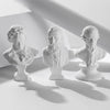 Three plaster bust miniatures of male figures with beards and hair, displayed in a studio setting.