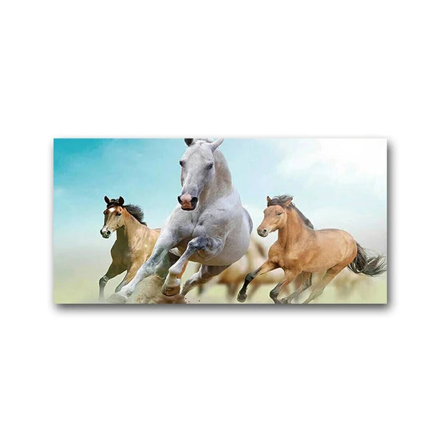 Three horses galloping across a misty field under a bright sky.