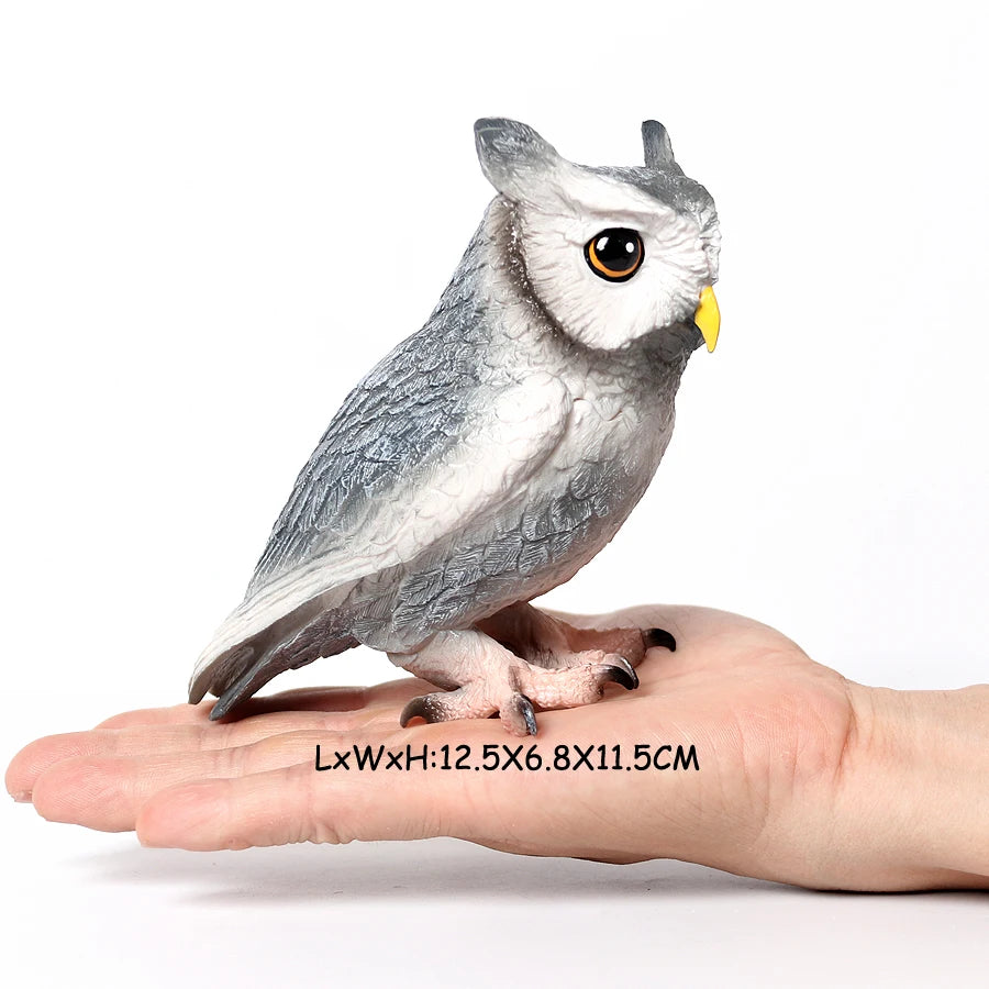 A realistic figurine of an owl perched on a human hand.