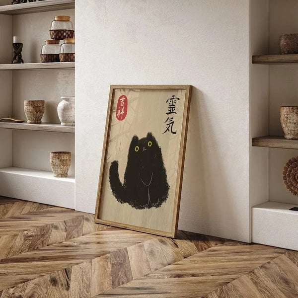 A framed canvas print featuring a black tiger cat illustration with Japanese text on a light wood background, displayed on a 