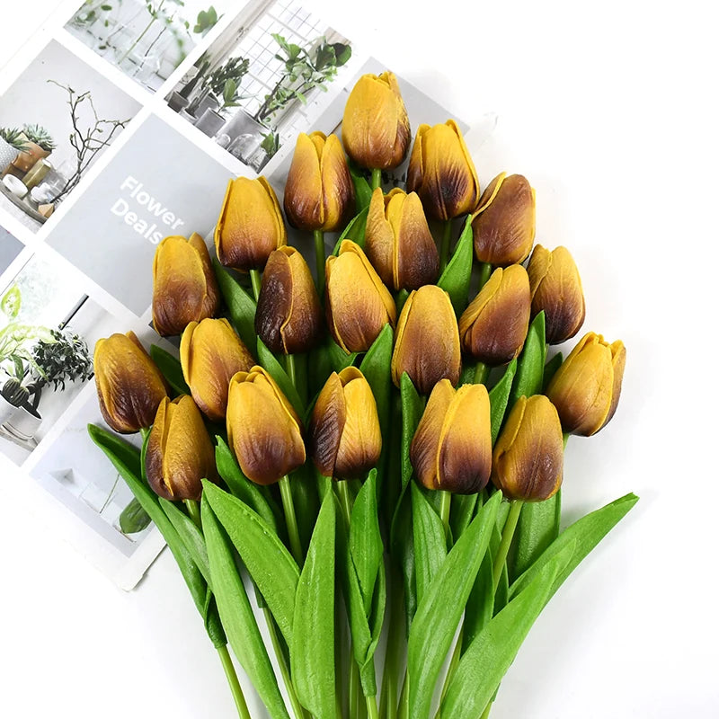 A bouquet of artificial yellow and brown tulips with green stems for decoration.