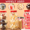 A set of six glass jars filled with various candies and ingredients, including gummies, nuts, and jellies, displayed against 