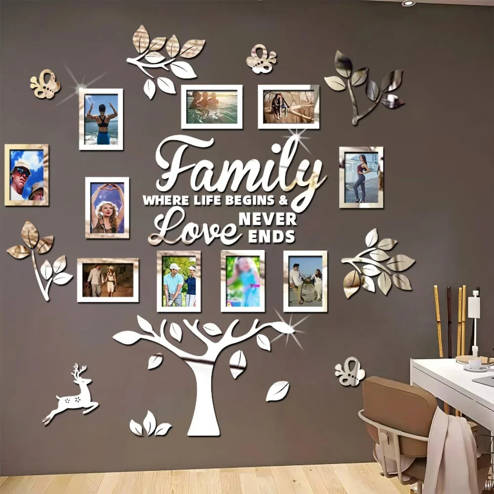 A wall decoration featuring a large tree silhouette made of white wood cutouts and framed family photos on a gray wall.