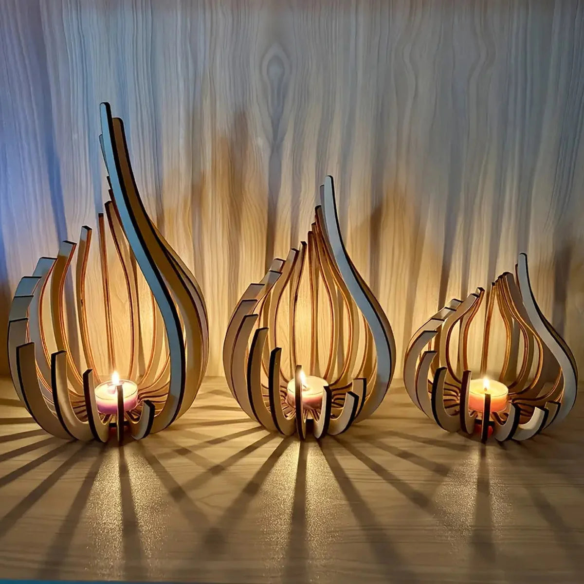 Handcrafted wooden lotus candle holder with a glowing flame set against a light wood background.