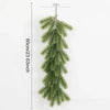 A long, artificial green pine garland hanging vertically against a white background.