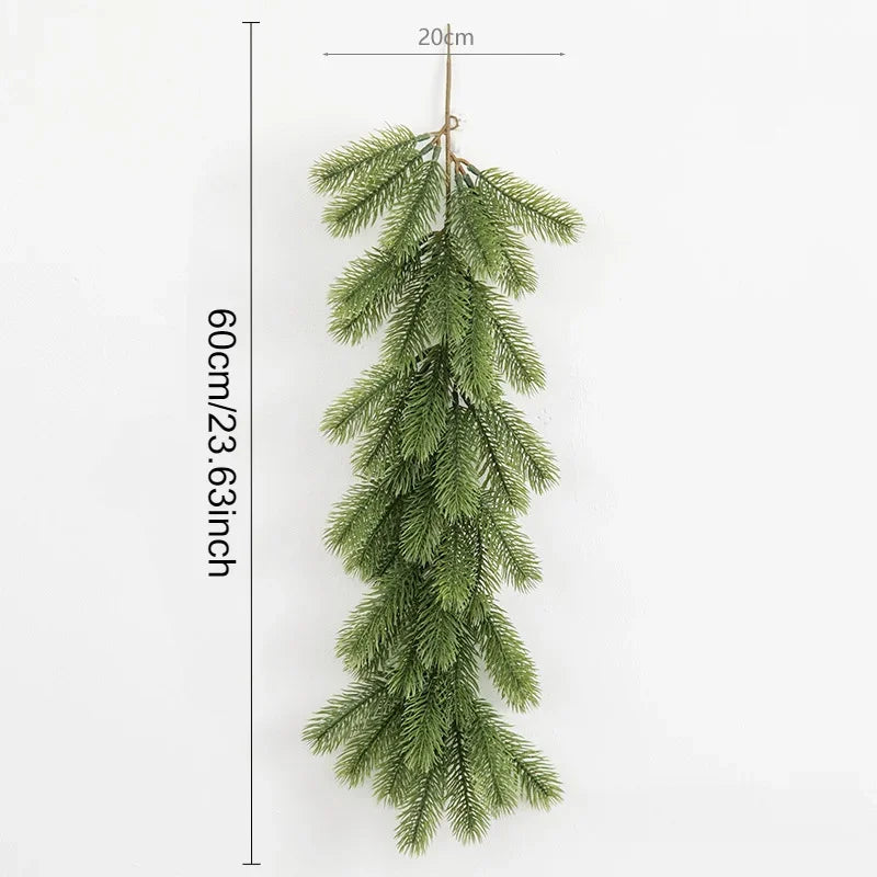 A long, artificial green pine garland hanging vertically against a white background.