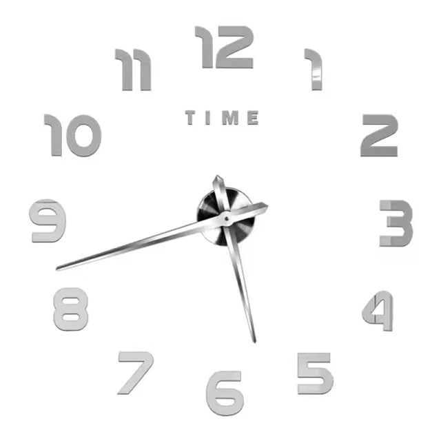 A silver-toned giant acrylic wall clock face with numbers 1 through 12 and a central pivot.