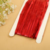 Red metallic tinsel foil fringe curtain backdrop for parties displayed on a light background.
