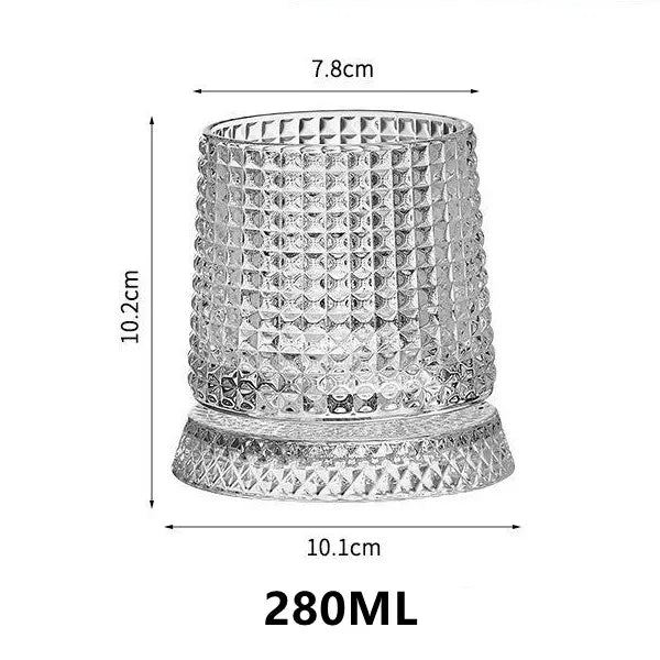 A clear crystal whiskey glass with a textured relief pattern and a matching coaster.